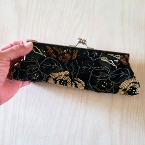 Beaded clutch with beaded strap.